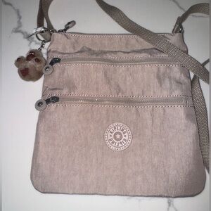 Kipling Tan Crossbody Bag with Adjustable Strap and Signature Charm